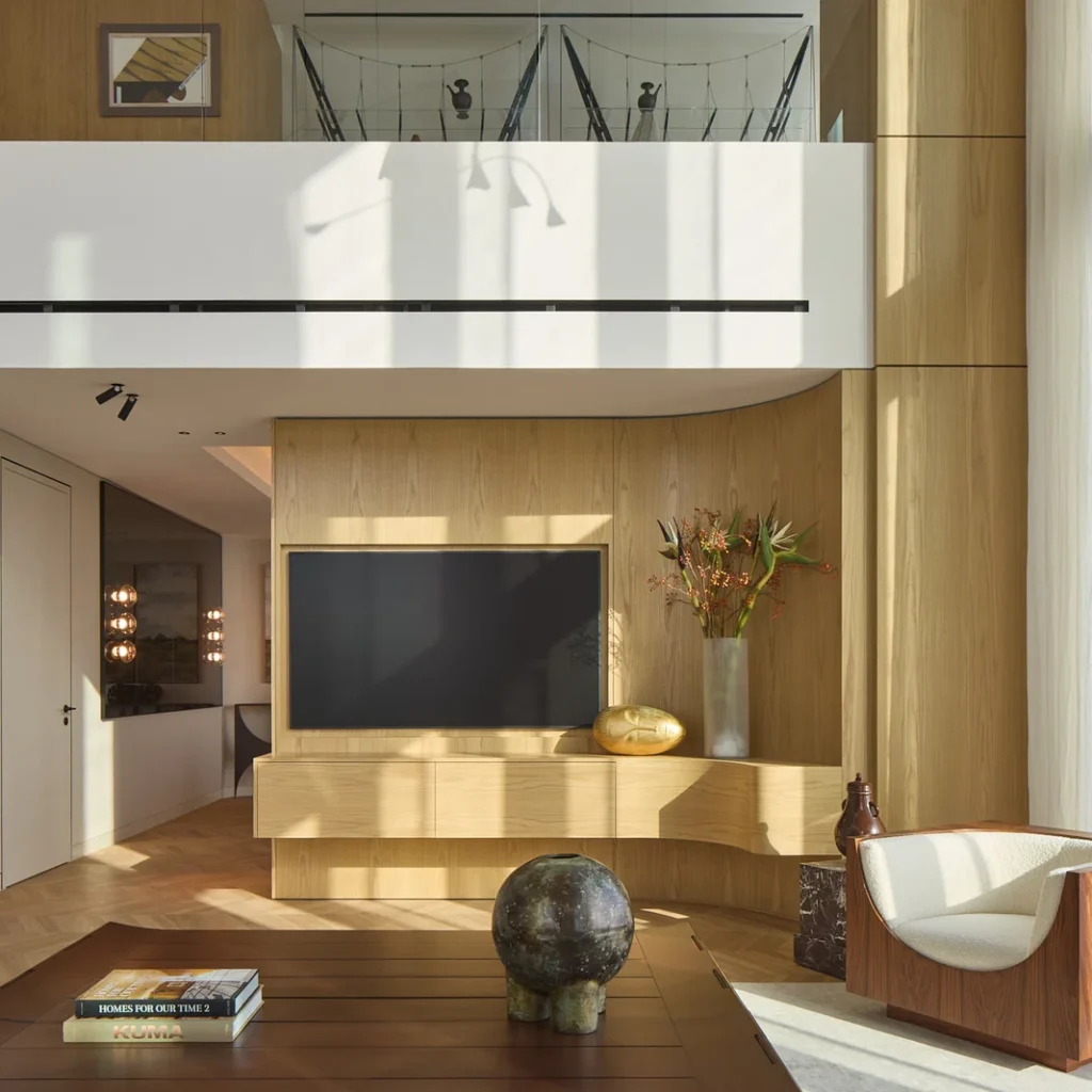 Duplex penthouse interior design in Dubai with a double-height living room, custom wood TV wall and contemporary furniture
