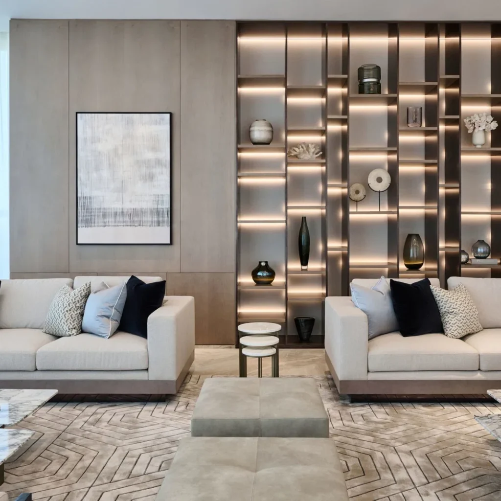 Bespoke penthouse living room design in Dubai with white sofas and custom illuminated display shelving