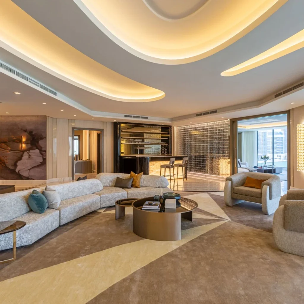 High-end penthouse fit out in Dubai featuring a sculptural illuminated ceiling, custom bar and contemporary living room