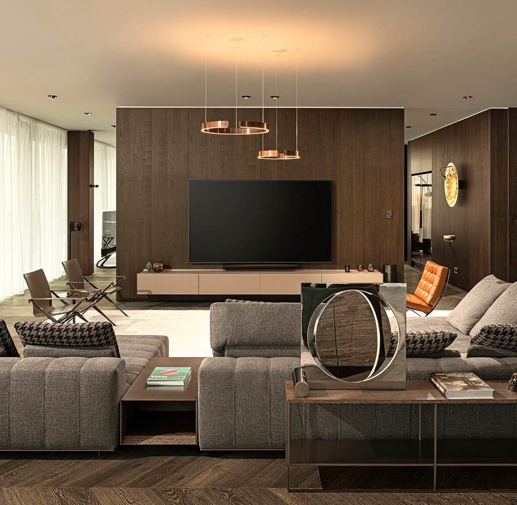 Modern apartment living room design in Dubai with grey sofas, custom wood TV wall and contemporary lighting