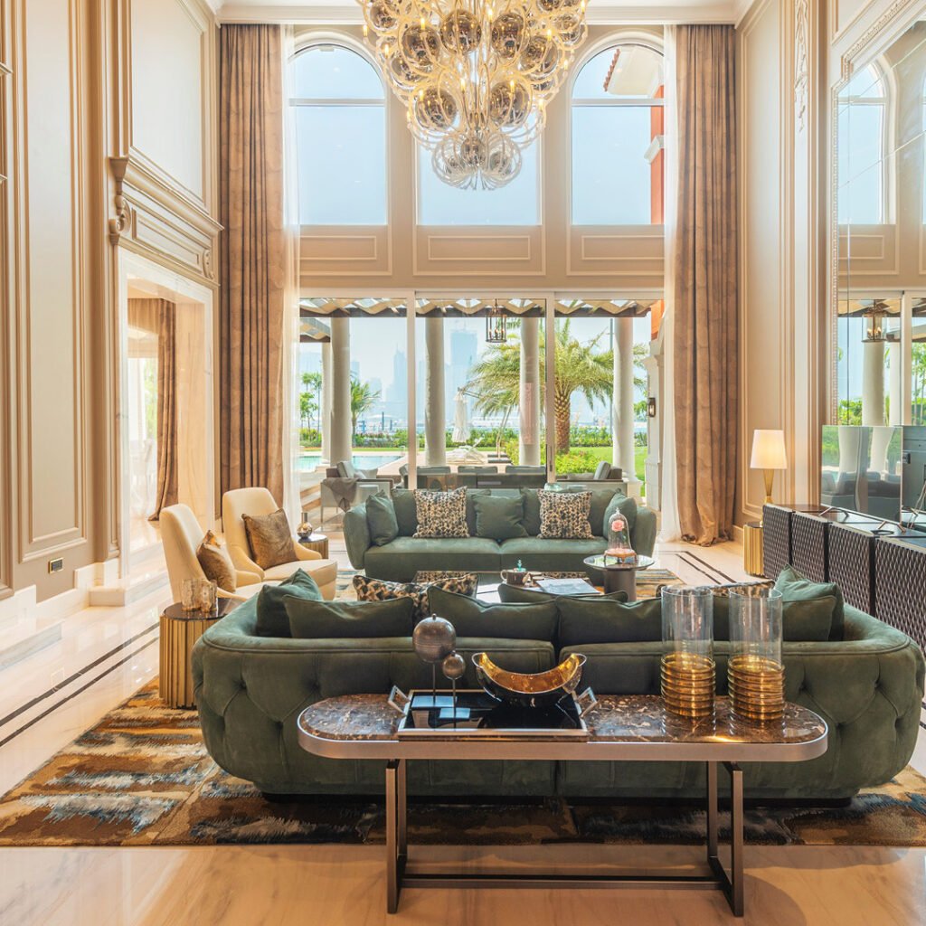 Classic villa fit out in Dubai featuring a double-height living room, decorative wall finishes and chandelier