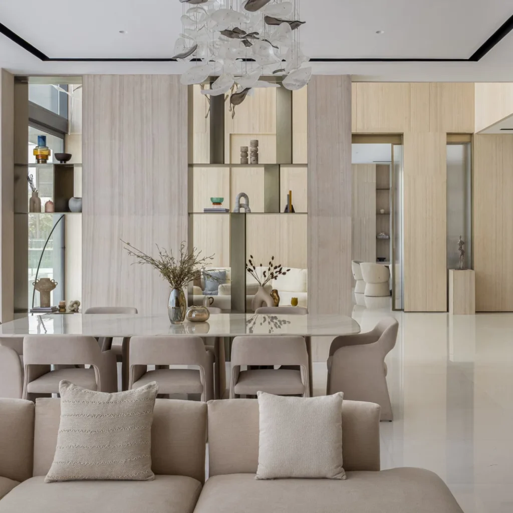 Villa renovation in Dubai dining area with contemporary furniture, custom shelving and sculptural ceiling lighting