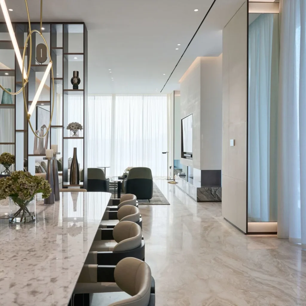 Open-plan penthouse interior design in Dubai with a marble dining counter and contemporary living area