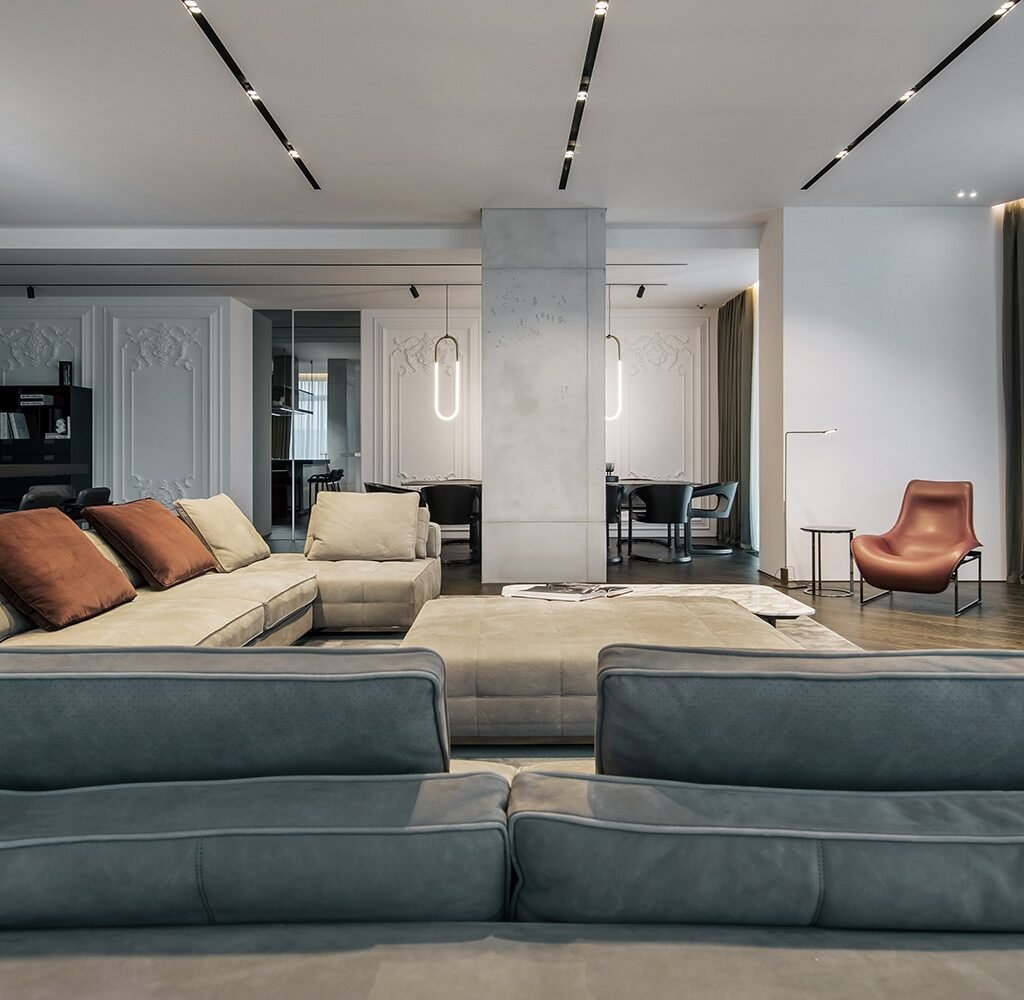 Open-plan apartment interior design in Dubai featuring a contemporary living room and dining area