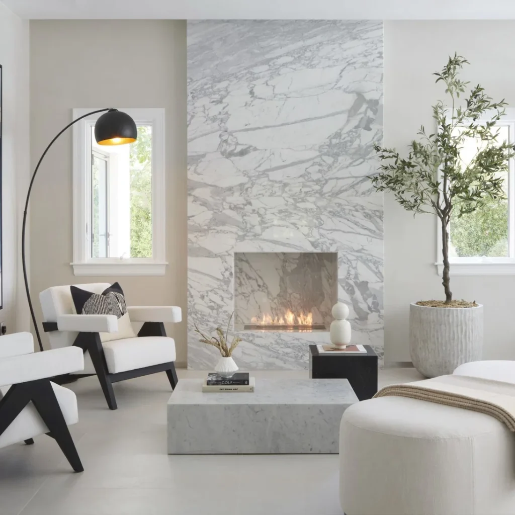 Apartment fit out in Dubai featuring a floor-to-ceiling marble fireplace and minimalist interior finishes