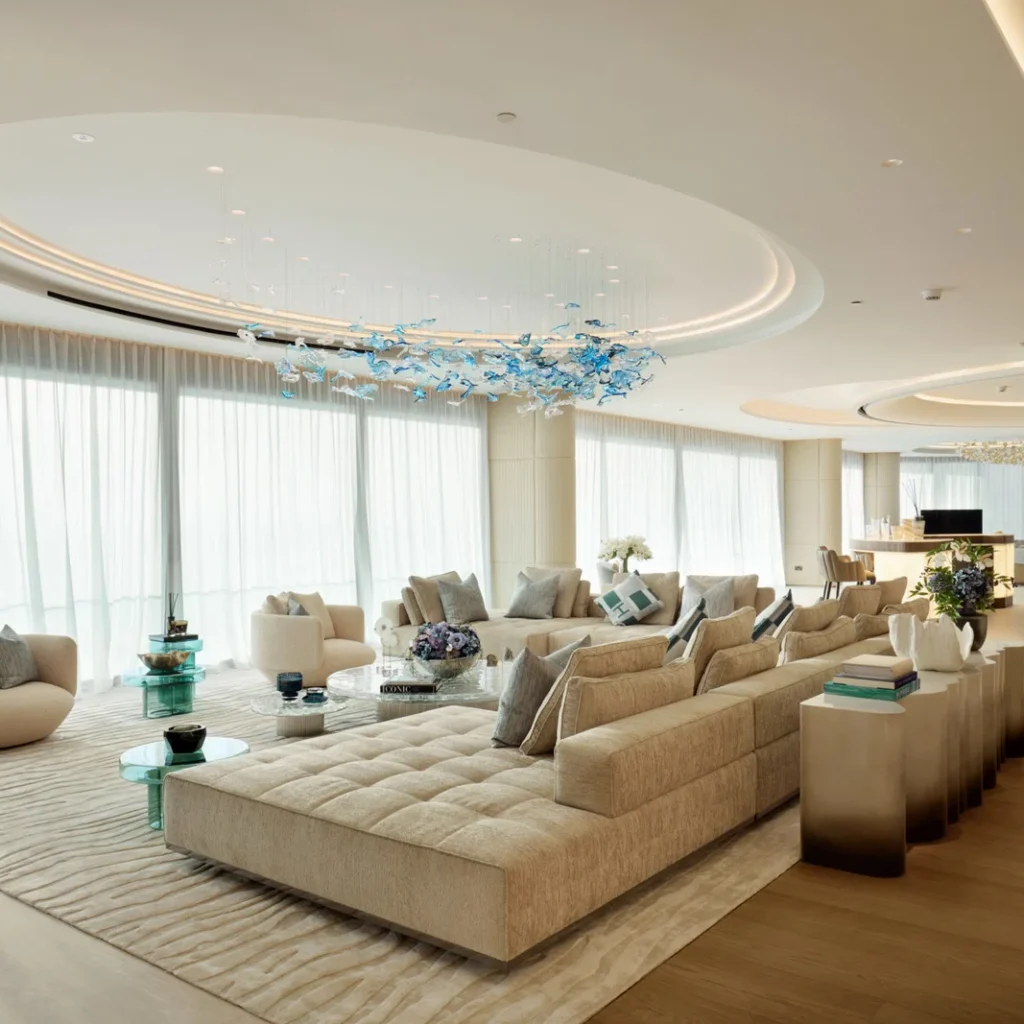Apartment renovation in Dubai featuring a spacious living room with neutral seating and sculptural ceiling lighting