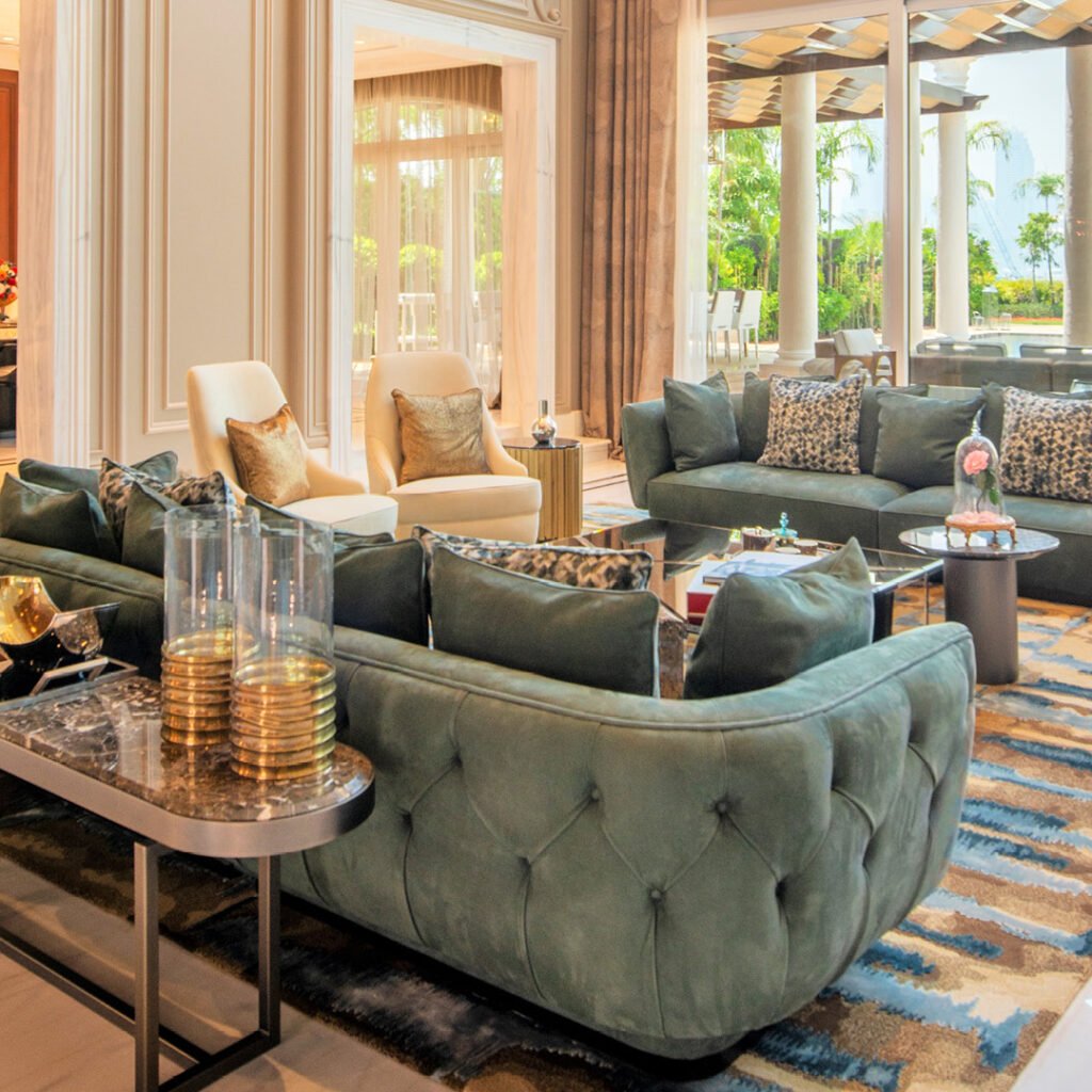 Villa lounge fit out in Dubai featuring green upholstered seating, custom finishes and floor-to-ceiling windows