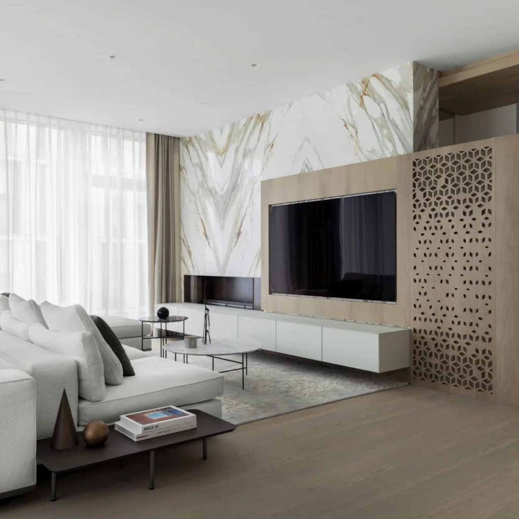 Apartment renovation in Dubai living room with marble TV feature wall, custom joinery and decorative timber screen