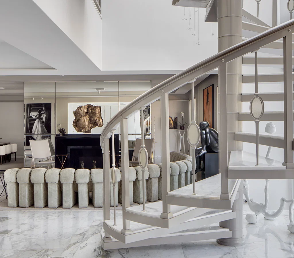 Apartment renovation in Dubai featuring a statement fireplace, mirrored wall and sculptural decorative artwork