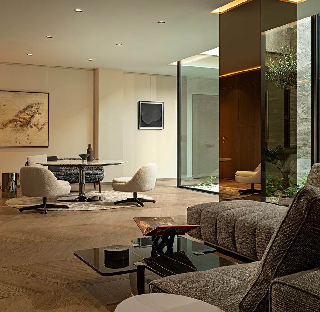 Contemporary apartment interior design in Dubai with an open living and dining area, artwork and indoor greenery