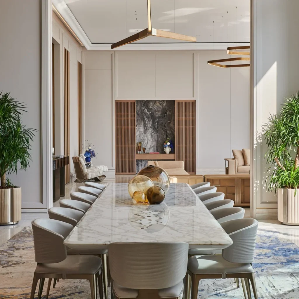 Villa renovation in Dubai dining room with large marble table, upholstered chairs and custom wall details