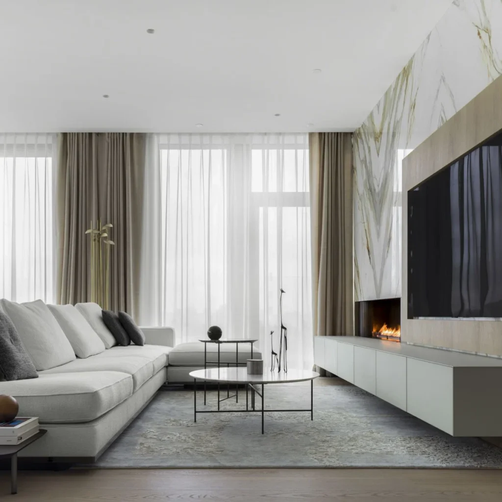 Apartment renovation in Dubai living room with marble feature wall, integrated fireplace and contemporary furniture