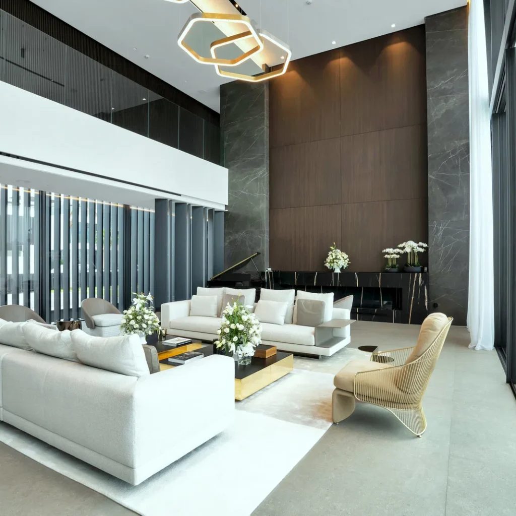 Turnkey villa fit out in Dubai featuring a double-height living room, wood wall panels and stone finishes