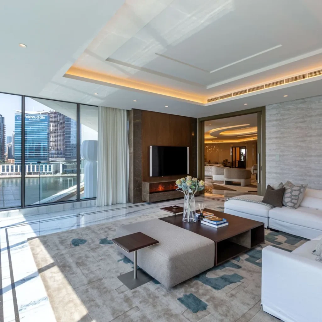 Waterfront apartment fit out in Dubai featuring marble flooring, custom TV wall and floor-to-ceiling windows