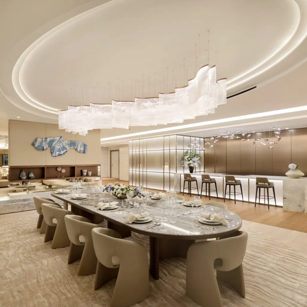 Apartment renovation in Dubai with open dining and kitchen area, statement lighting and custom cabinetry