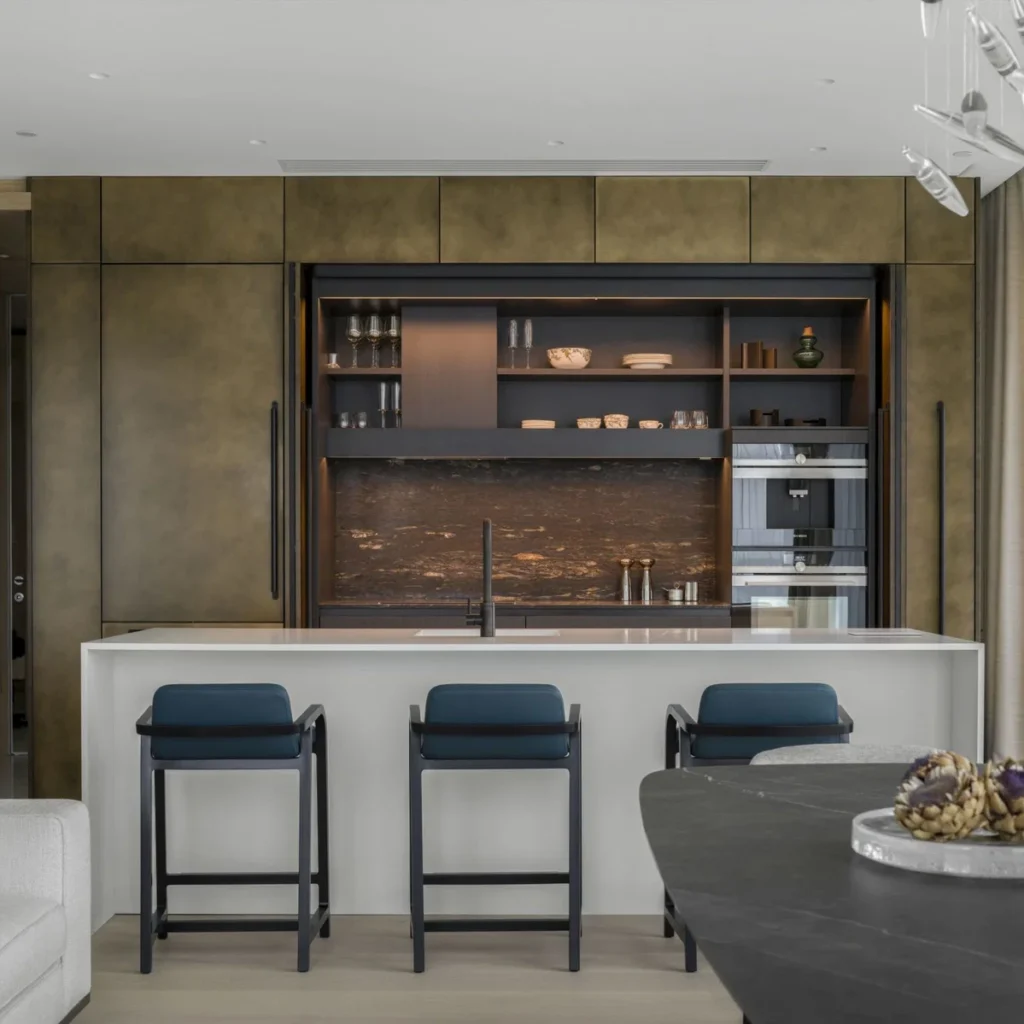Apartment renovation in Dubai featuring a modern kitchen with island, fitted cabinetry and integrated appliances