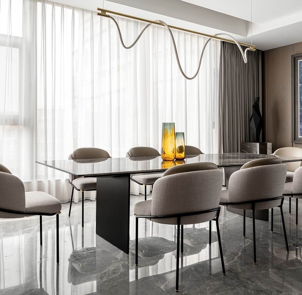 Penthouse dining room interior design in Dubai with contemporary seating and sculptural statement lighting