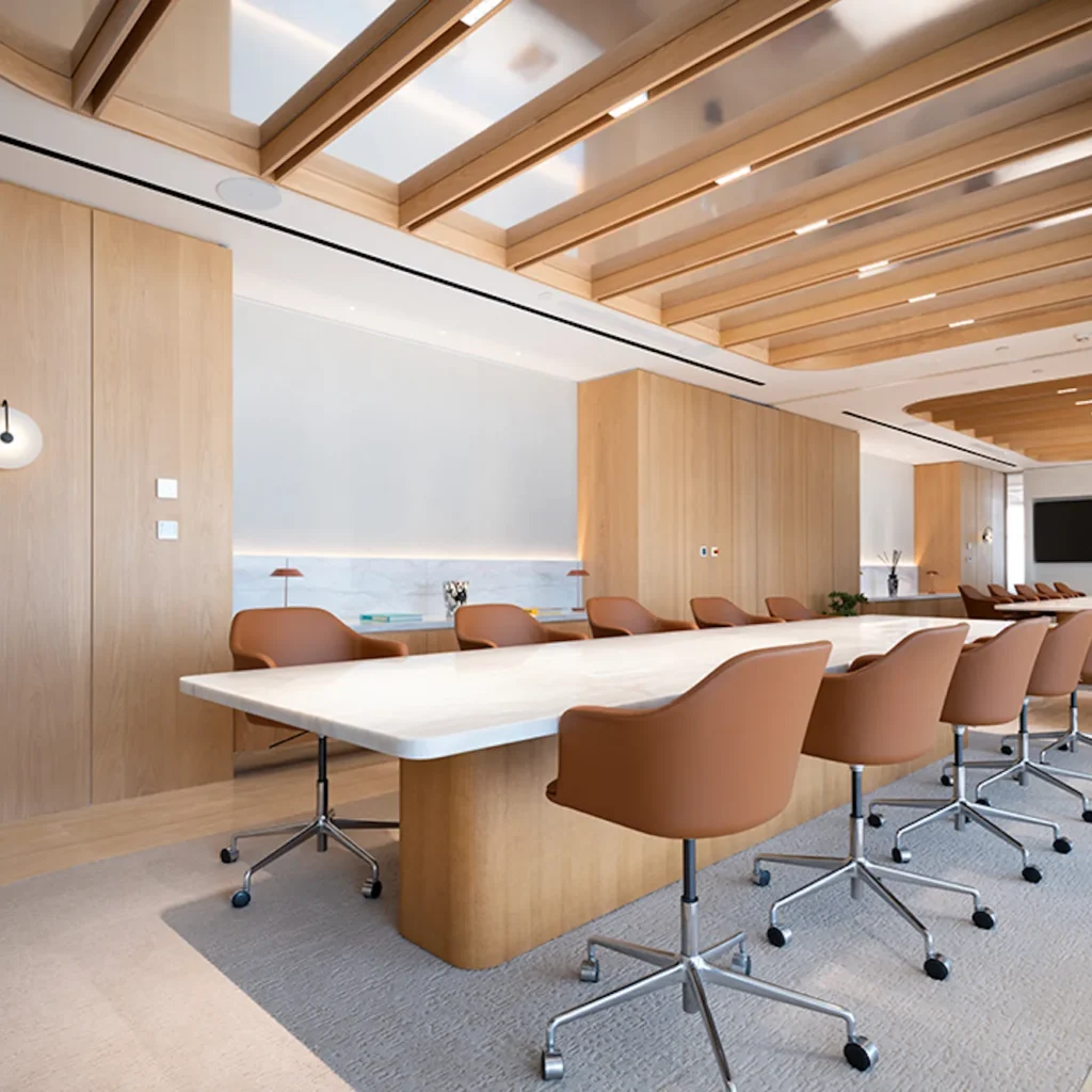Commercial interior design in Dubai featuring a modern boardroom with timber finishes and custom meeting furniture