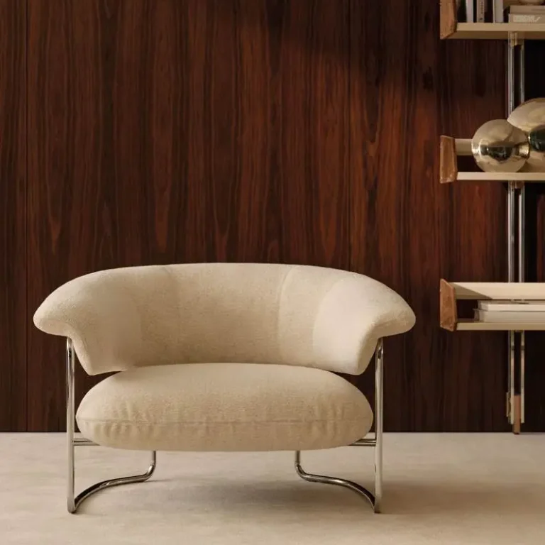 Contemporary upholstered armchair with curved metal frame for a high-end Dubai interior design concept