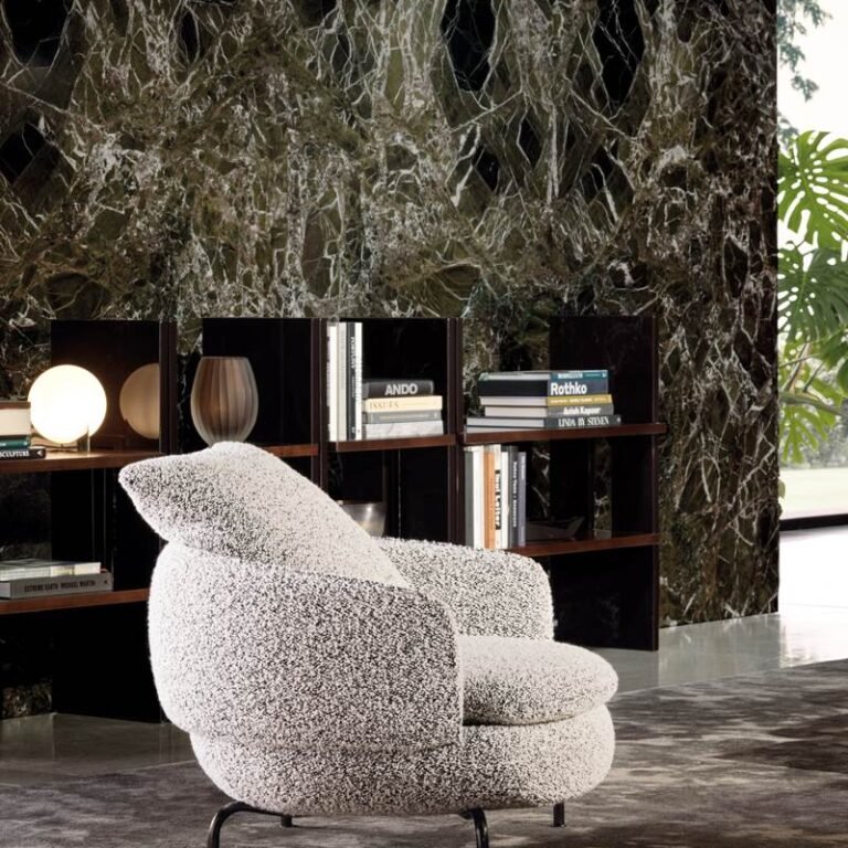 Custom furniture services – curved textured armchair beside dark shelving and a veined stone wall