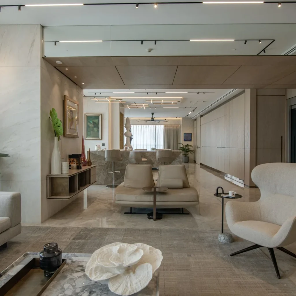 Penthouse renovation in Dubai featuring an open-plan lounge with contemporary seating, marble finishes and custom lighting
